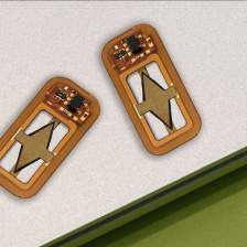 Two copper colored cartridges with a diamond shape in the middle