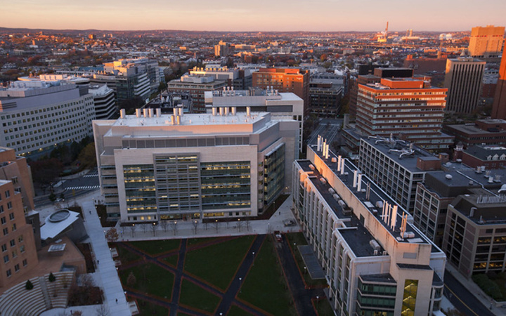 Aerial view of the Koch Institute building at sunset with Kendall Square stretching out beyond