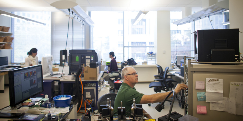 A spacious, light-filled lab with staff working computers and scientific equipment