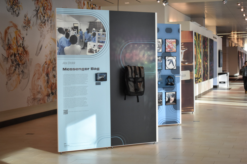 A panel display in a gallery featuring a backpack