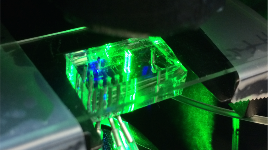 translucent brick with electronics threaded through it, lighted up bright green