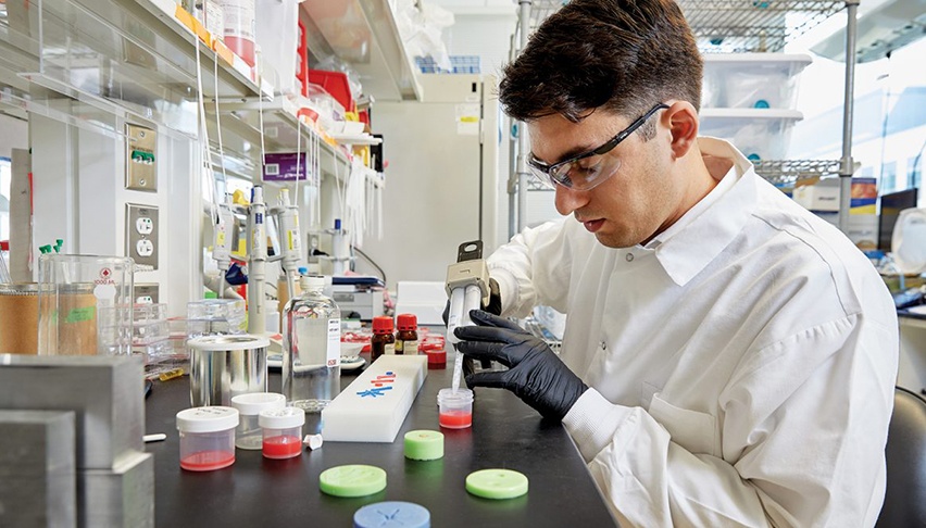 researcher pipetting at a lab bench