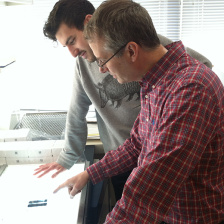 Matt Vander Heiden and a trainee discuss an image on a lightbox