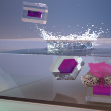 cube-like capsules fall into liquid and release a splash of dye