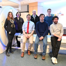 Regina Barzilay and the Sybil team posing by a CT scanner