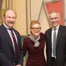 Two men and a woman posing for a photo 