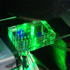 translucent brick with electronics threaded through it, lighted up bright green