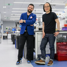 Strand Therapeutics founders Jake Becraft (left) and Tasuku Kitada standing in a lab