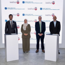 Three men and a woman standing