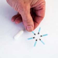 A hand holds one prong of a star-shaped, six-pointed device