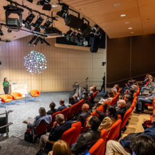 Sangeeta Bhatia speaking onstage in front of an audience