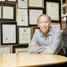 Photo of Robert Langer sitting at a table in his office