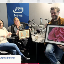 Three people sitting in the WGBH News studio. There is a text box at the bottom with the names of the guests: Sangeeta Bhatia and Angela Belcher and the text in the upper right hand corner says The Curiosity Desk