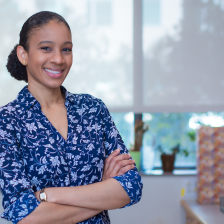 Photo of Whitney Henry in her lab, wearing a blue and white flowered shirt