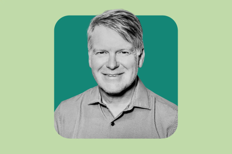 Light green background and in the center is a dark green square featuring a black and white headshot of Darrell Irvine