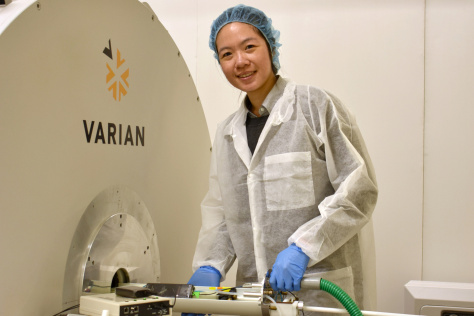 Co-lead author Leanne Li standing by mini-MRI used in the study.