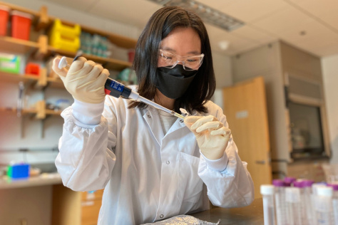 a student uses a pipette in a lab