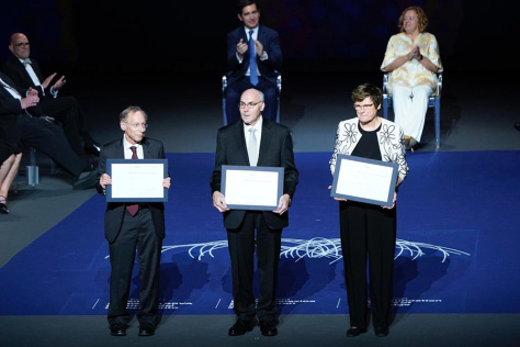 Robert Langer, Drew Weissman, and Katalin Karikó on a stage with BBVA Award plaques