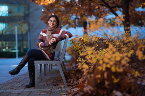 Nidhi Juthani sitting on a bench on MIT campus