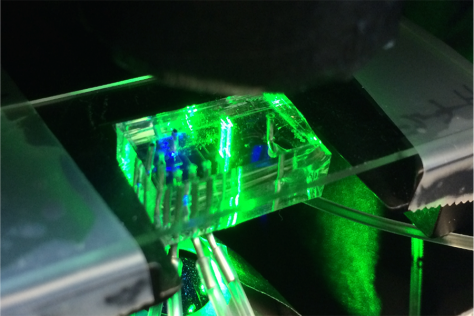 translucent brick with electronics threaded through it, lighted up bright green