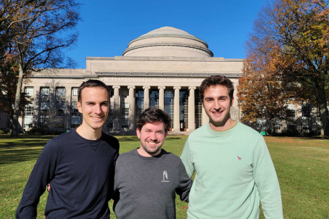 Photo of three men in Gabriele Corso, Jeremy Wohlwend, and Saro Passaro - standing in front of MIT's Great Dome and smiling for the camera. 