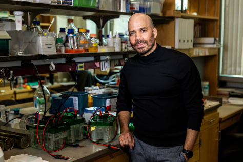 Photo of Eliezer Calo in his lab, wearing a black shirt