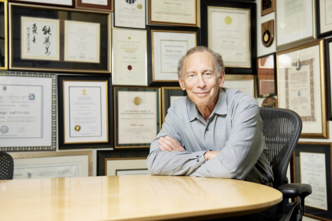 Photo of Robert Langer sitting at a table in his office