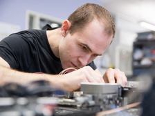Researcher works intently on a mechanical device
