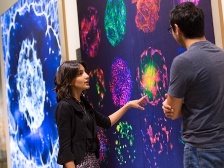 Asha Patel points out a detail on a fluorescent image
