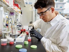 researcher pipetting at a lab bench